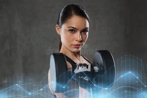 Young Woman Flexing Muscles With Dumbbells In Gym Stock Image Image