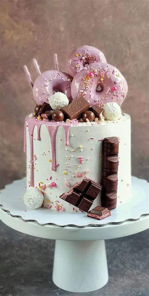 A White Cake With Pink Frosting And Sprinkles