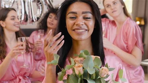 Free Stock Video Woman Holding Bouquet Wearing Pink Silk Nightdress Smiling While Touching