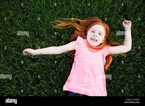 Caucasian Girl Laying In Grass Stock Photo Alamy