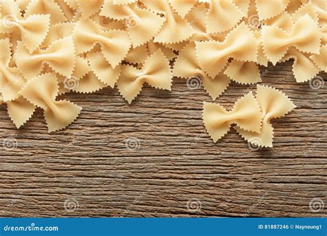 Dry Butterfly Pasta On A Wooden Background Bow Tie Pasta Stock Photo
