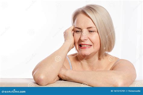 Portrait Of Cheerful Senior Woman Smiling While Looking Away At Spa