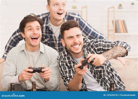 Gamers Happy Friends Playing Video Games At Home Stock Photo Image