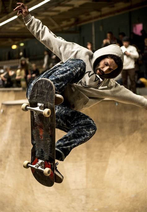 Man Riding Skateboard And Doing Ollie Trick