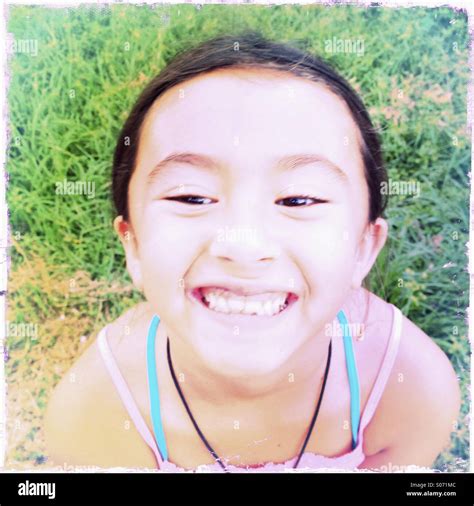Close Up Portrait Of A Grinning Seven Year Old Asian American Girl