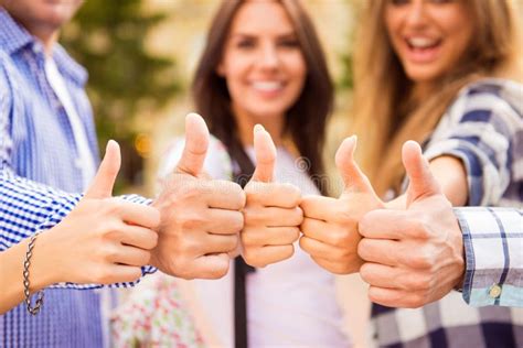 Close Up Photo Of Group Of Happy Students Showing Thumbs Up Stock Photo
