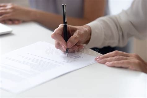 Close Up View Female Hand Signing Contract Legal Document Stock Image