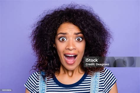 Head Shot Portrait Of Crazy Mad Girl With Wide Open Mouth Eyes Yelling Loudly Isolated On Violet