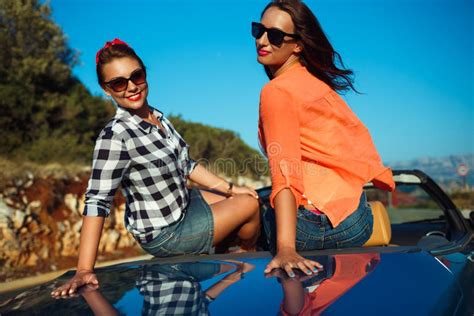 Two Young Happy Girls Having Fun In The Cabriolet Outdoors Stock Image