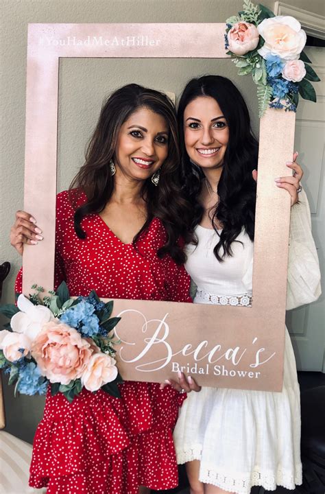 Two Women Holding Up A Sign That Says Berea S Bridal Shower