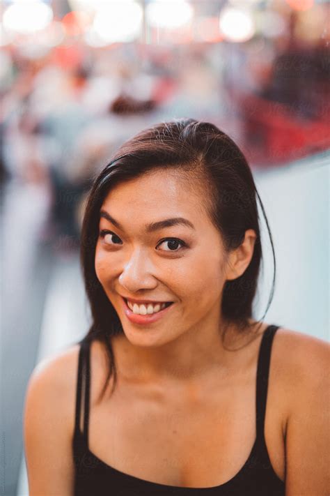 View Smiling Asian Woman Portrait In Time Square By Stocksy
