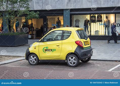 Small Yellow Electric Car Parked On The Street Editorial Photography