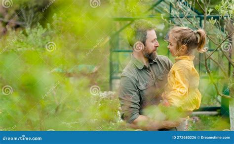 father with his little daughter bonding in front of eco greenhouse sustainable lifestyle stock