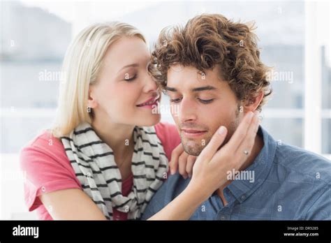 Woman About To Kiss Man On His Cheek Stock Photo Alamy