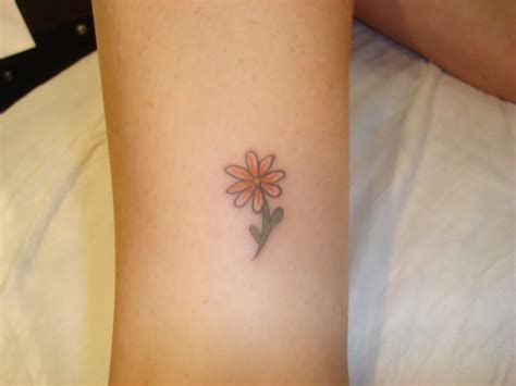 Women Love Ankle Tattoos And Here Is A Simple Yellow Daisy Tattoo