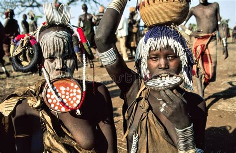 Two Woman Of The Mursi Tribe With Their Clay Discs In Their Under Lips