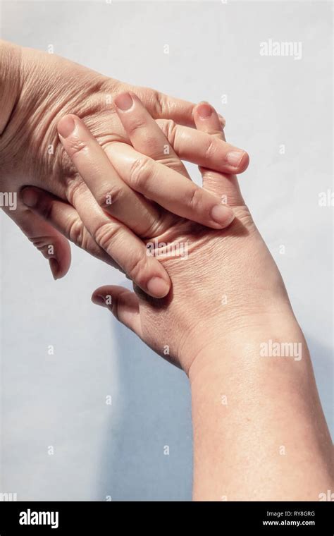 Two Interlocking Hands Hi Res Stock Photography And Images Alamy