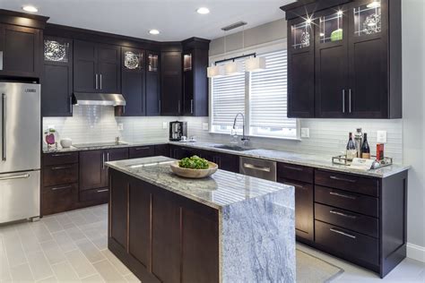 While renovating your kitchen, try on some new ideas for the upper shelves. Dark Kitchen Cabinets | Owings Brothers Contracting
