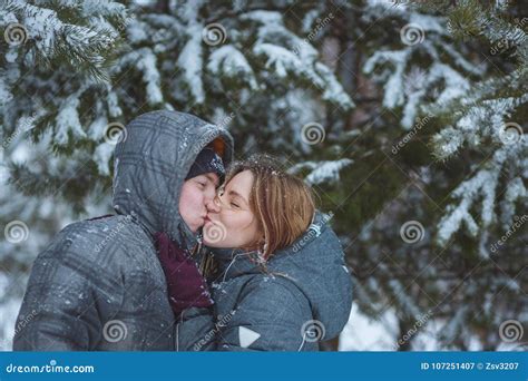 Happy Snow Covered Couple Kissing Under Fir Branches In Winter Forest Concept Healthy Romantic