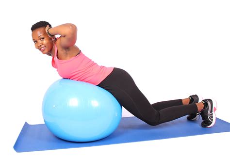 Smiling Woman Doing Back Extensions Exercise On Swiss Ball High