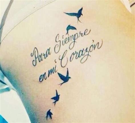 The Back Of A Womans Stomach With Birds Flying Around Her And Words