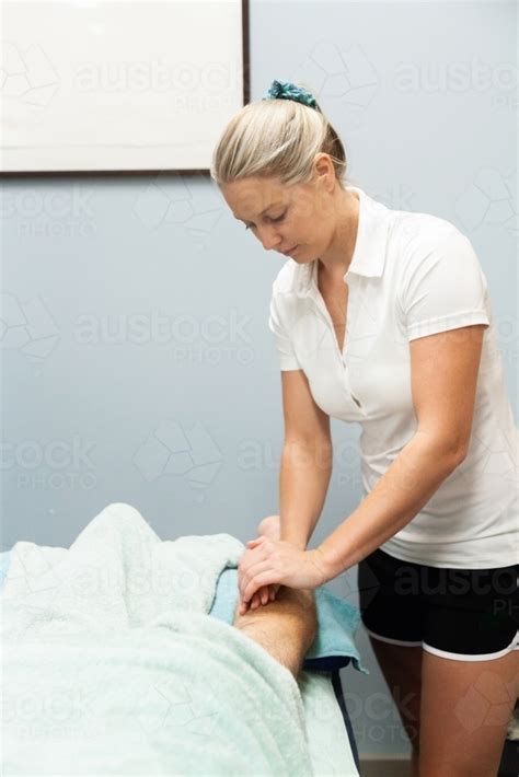 Image Of Masseuse Massaging Clients Leg Austockphoto