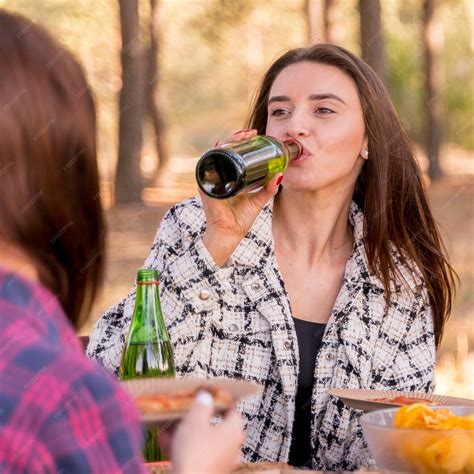 Free Photo Woman Drinking Beer While Outdoors With Friends