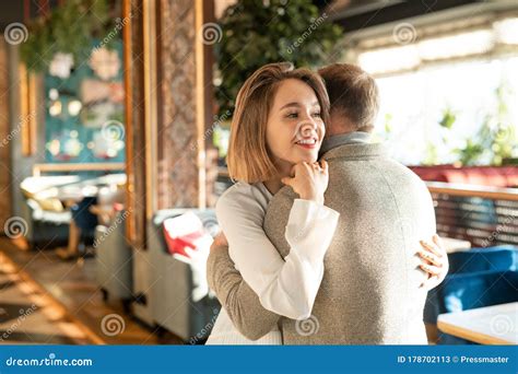 Happy Young Smiling Woman Embracing Her Affectionate Boyfriend Stock