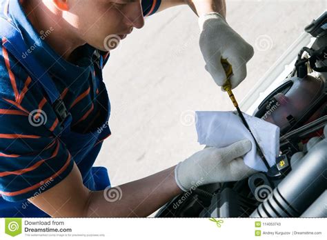 Specialist In Car Maintenance Checks The Engine Oil Level Of The Car