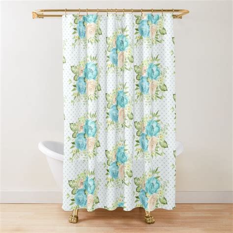 A Shower Curtain With Blue And Green Flowers On White Polka Dotty Fabric In Front Of A Bathtub