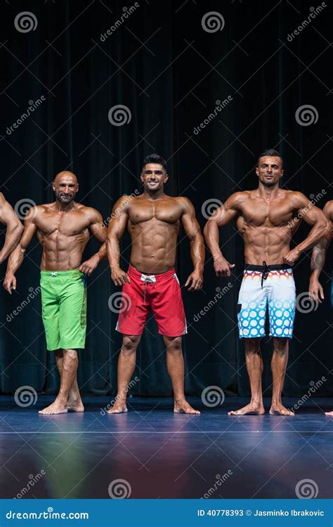 Mens Physique Posing During A Bodybuilding Competition Stock Image