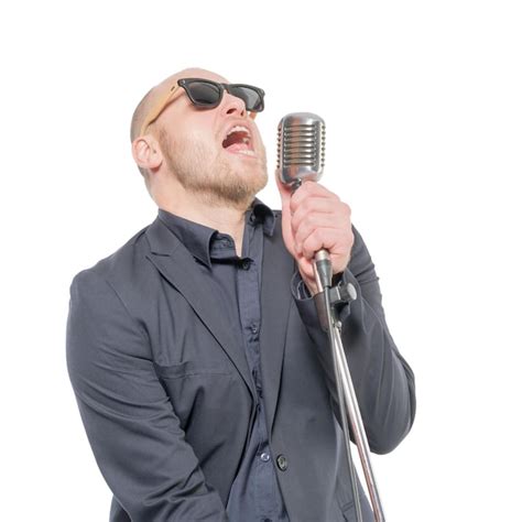 Premium Photo A Man In A Gray Jacket Bow Tie And Sunglasses Singing