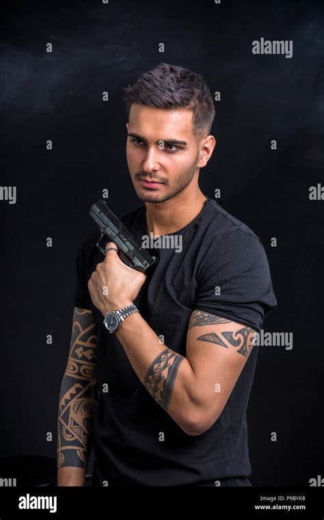 Young Man Holding Hand Gun Stock Photo Alamy