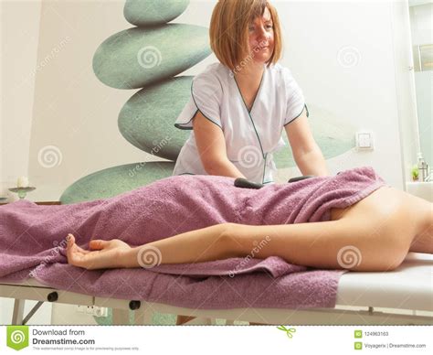 Female Masseuse Doing Massage With Hot Stones Stock Image Image Of