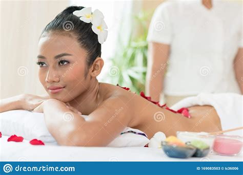 Young Beautiful Woman Lying In Bed Covered By Flower In Spa Massage Stock Image Image Of Human