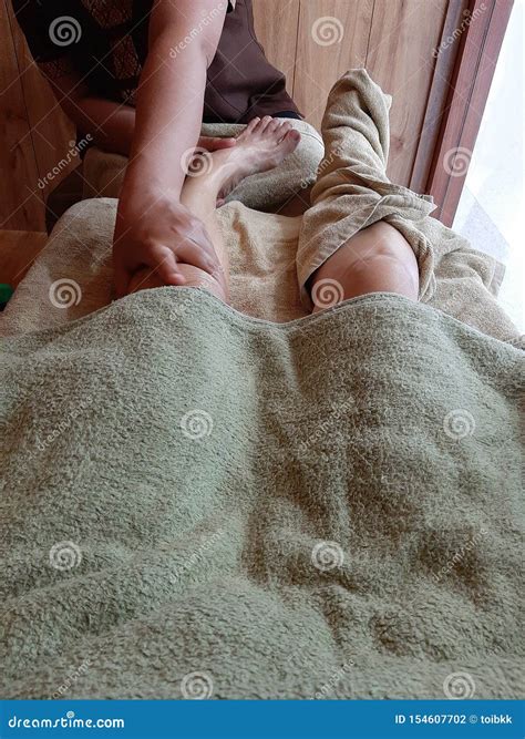 Traditional Thai Foot Massage Masseuse Does Massage Woman`s Leg And Wrap Another Foot By Towel