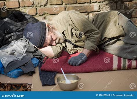 Tired Homeless Old Man Sleeping On Cardboard In The Street Royalty Free Stock Photography