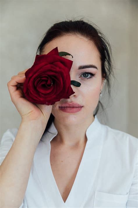 A Brunette Woman Closed Her Eye With A Red Rose Flower Stock Image