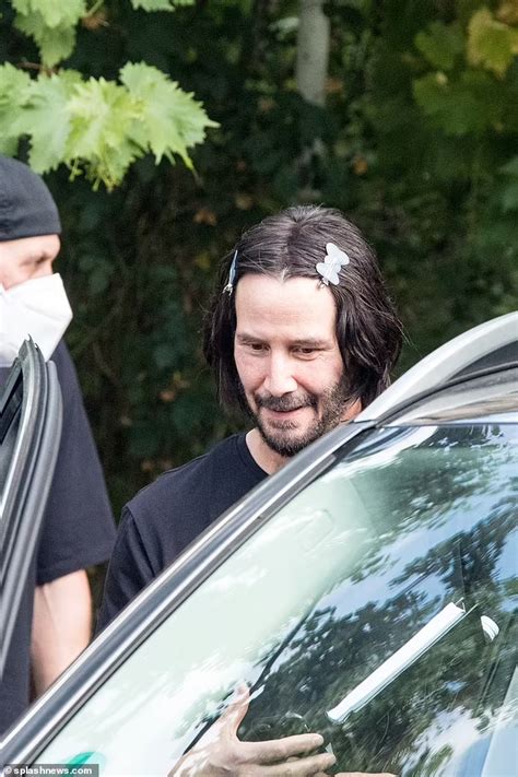 Keanu Reeves 56 Clips His Dark Locks Back With Hair Slides Daily Mail Online Keanu Reeves