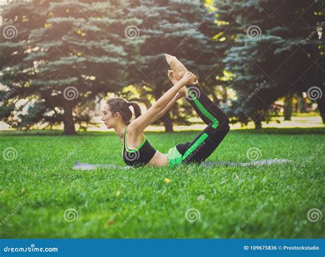 Woman Training Yoga In Bow Pose Outdoors Stock Photo Image Of Concept
