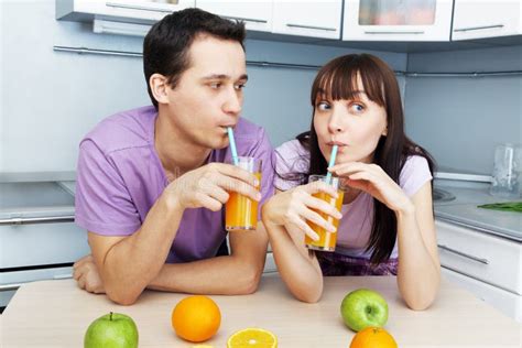 Couple Drinking Orange Juice In The Kitchen Stock Image Image Of Male Beautiful 85788589