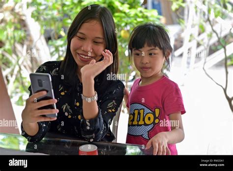 Young Woman And A Little Girl Playing With A Smartphone Lasem Java
