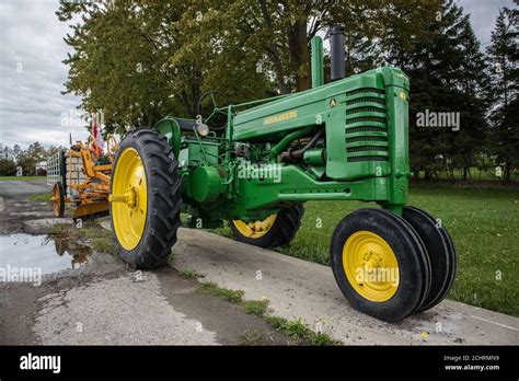 A John Deere Model A Tractor Pulling A Plow Stock Photo Alamy