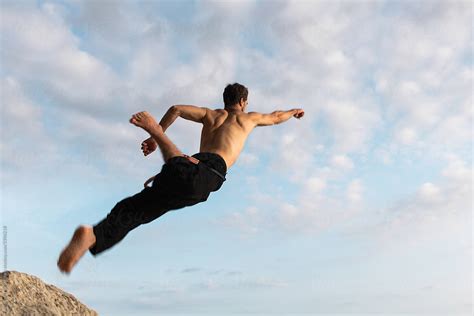 Man Jumping Up To The Sky By Stocksy Contributor Alexander