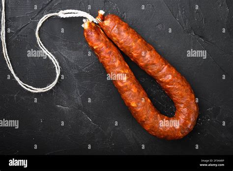 Spanish Pork Chorizo Sausages On Black Textured Background Stock Photo