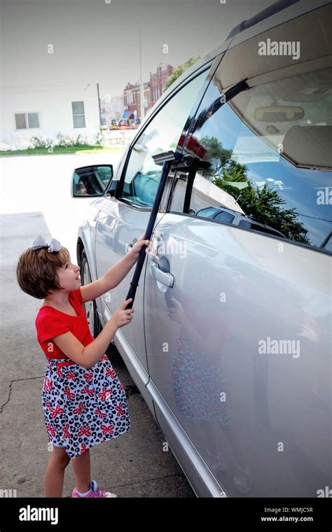 Cute Girl Cleaning Car At Gas Station Stock Photo Alamy