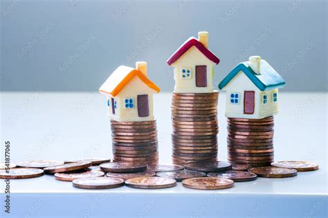 Houses On Top Of Stacks Of Coins Concepts Mortgages House Market Or
