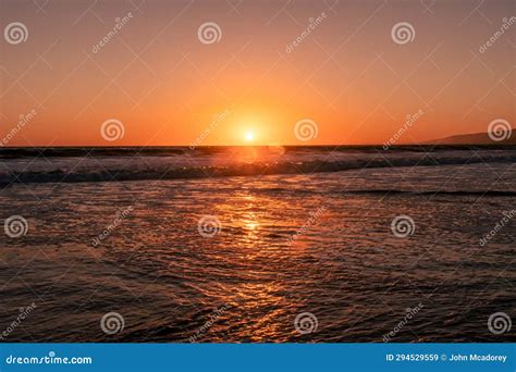 A Pacific Ocean Sunset In California With Reflections On The Water