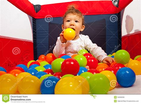 Baby Playing With Colorful Balls Stock Photo Image Of Background