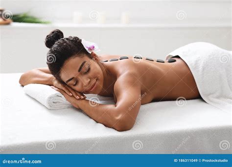 African Girl Lying At Spa Salon Getting Hot Stone Massage Stock Image Image Of Attractive